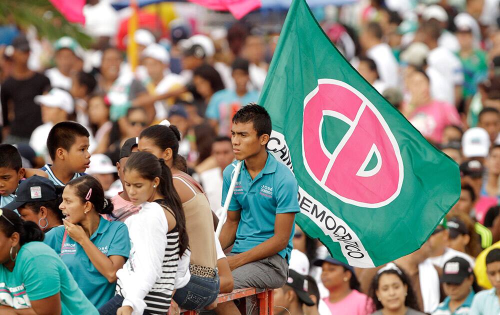 Supporters of Jose Domingo Arias, Presidential candidate for the ruling Democratic Party hold up a flag during their closing campaign rally in Panama City.