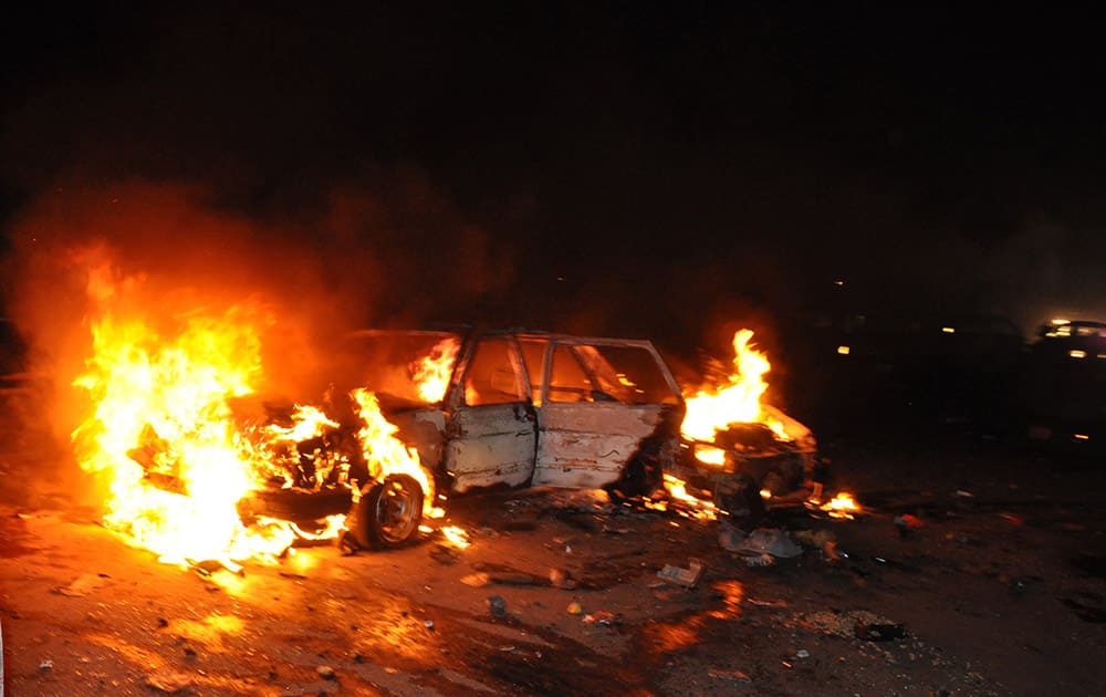 A car burns following a bomb explosion in Abuja, Nigeria. A car bomb exploded on a busy road in Nigeria`s capital late Thursday, killing at least 12 people days before the city is to host a major international economic forum. 