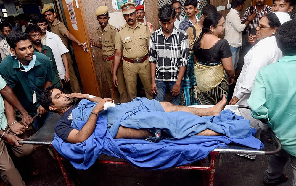 An injured passenger being shifted to a hospital after explosion in the two coaches of a train in Chennai.