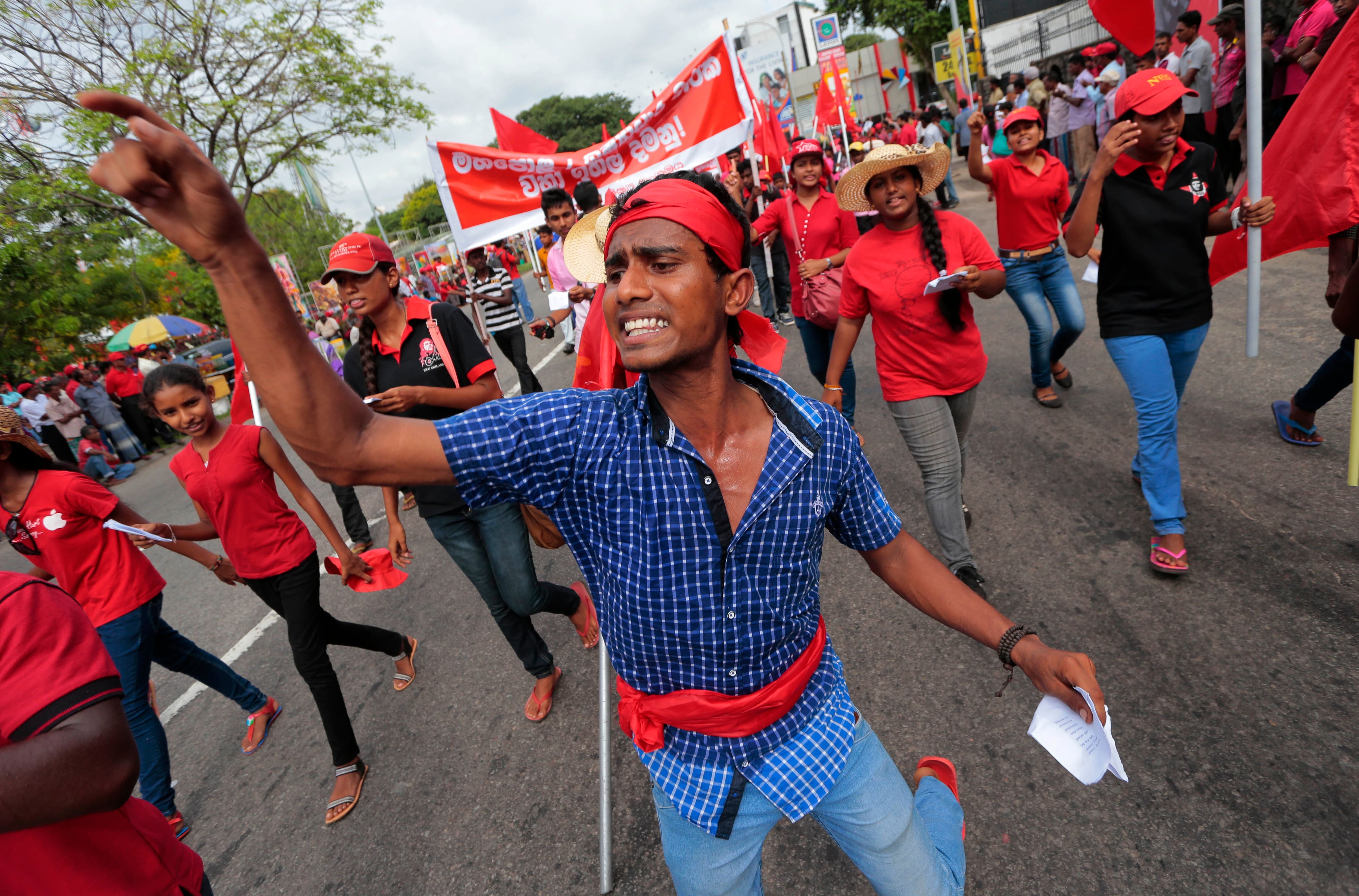 A member of Sri Lanka`s Marxist Party Peoples Liberation Front shouts slogans against the Sri Lankan government during a parade held to mark the International Labor Day or May Day in Colombo, Sri Lanka.