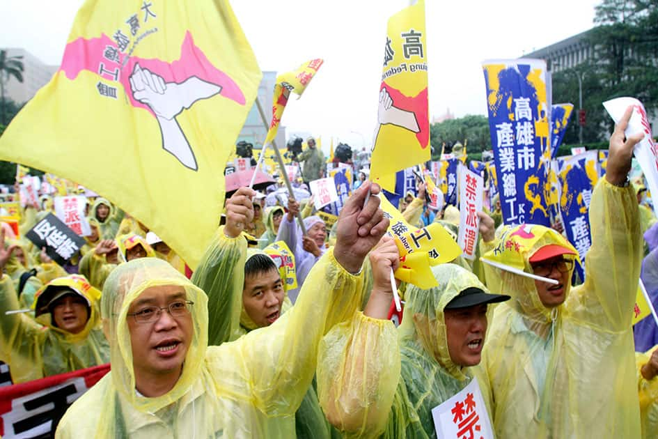 Labor rights activists shout slogans during a rally on international Labor Day in Taipei, Taiwan.