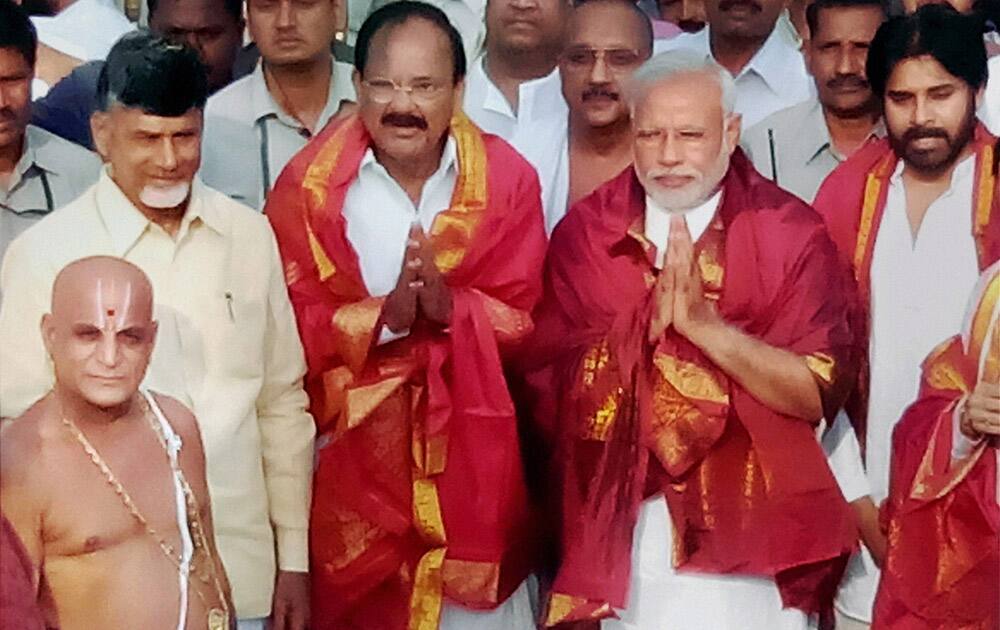 BJP Prime Ministerial candidate Narendra Modi with TDP President N. Chandrababu Naidu, BJP leader M. Venkaiah Naidu and Janasena founder Pawan Kalyan walk out after offering worship,of Lord Venkateswara temple at Tirumala in Tirupati.