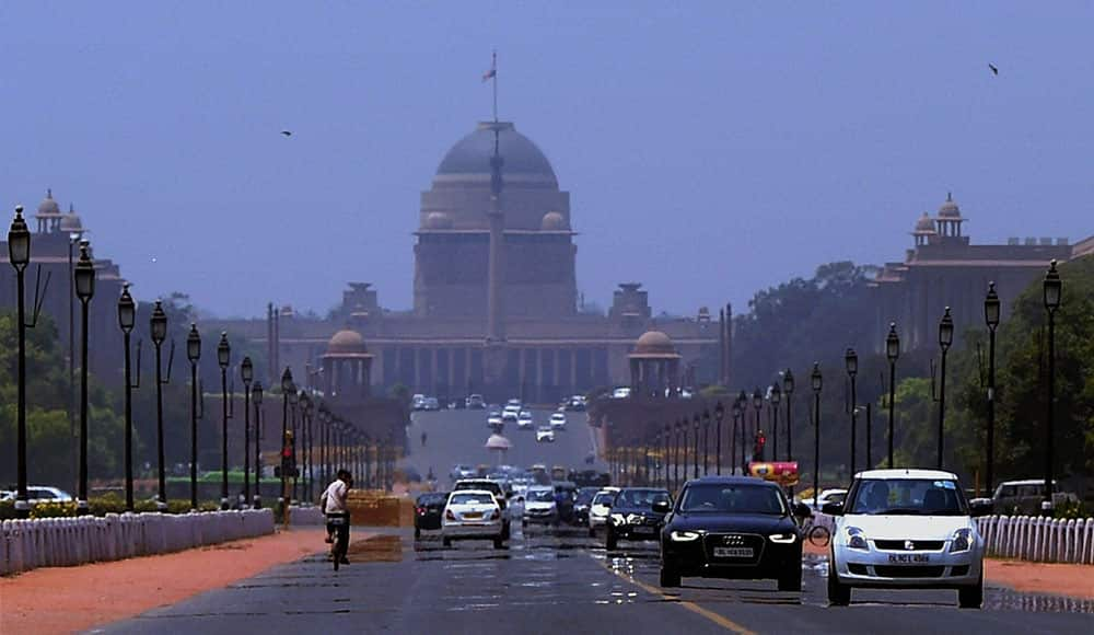 Mirage appears at Rajpath as vehicles move, on a hot day in New Delhi.