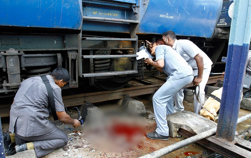 Blood lies splattered as bomb squad personnel inspect a passenger train that was ripped by two blasts at the railway station in Chennai. Twin blasts ripped through two coaches of the train Thursday morning just minutes after it pulled into Chennai railway station, one of India`s busiest train stations, killing a 22-year-old woman and injuring 14 people, officials said.