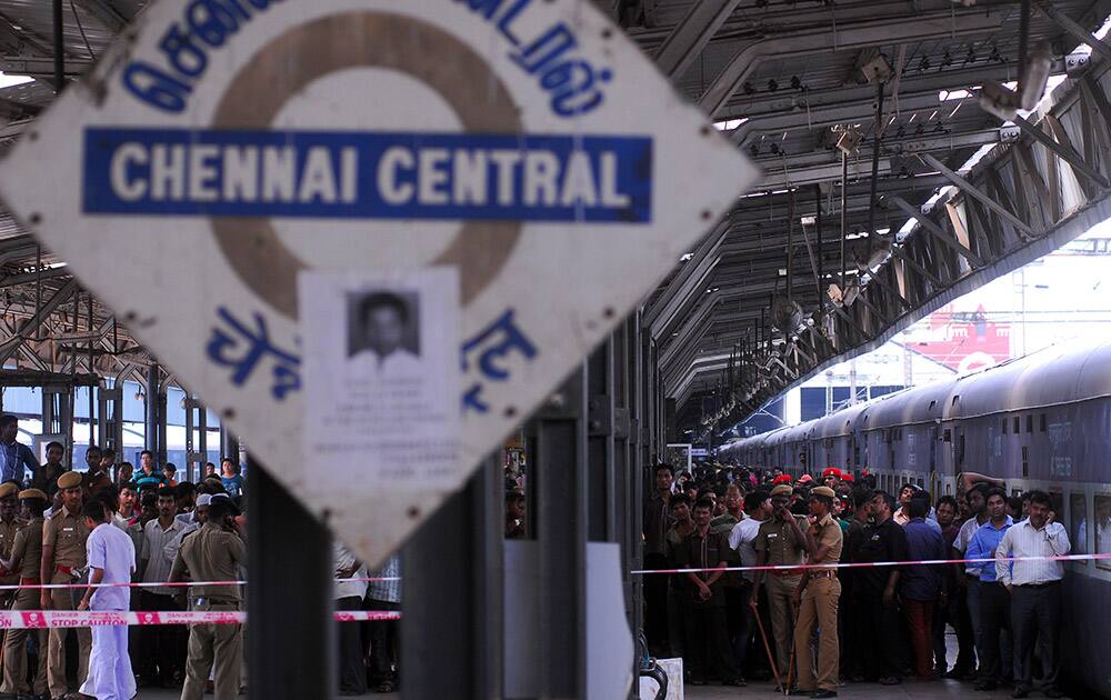 Policemen and passengers crowd a railway platform where a train was ripped by two blasts in Chennai. Twin blasts ripped through two coaches of the train Thursday morning just minutes after it pulled into Chennai railway station, one of India`s busiest train stations, killing a 22-year-old woman and injuring 14 people, officials said.