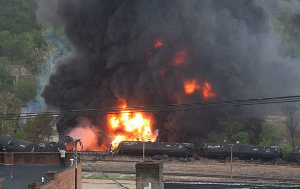 This image made available by the City of Lynchburg, shows several CSX tanker cars carrying crude oil in flames after derailing in downtown Lynchburg, Va.