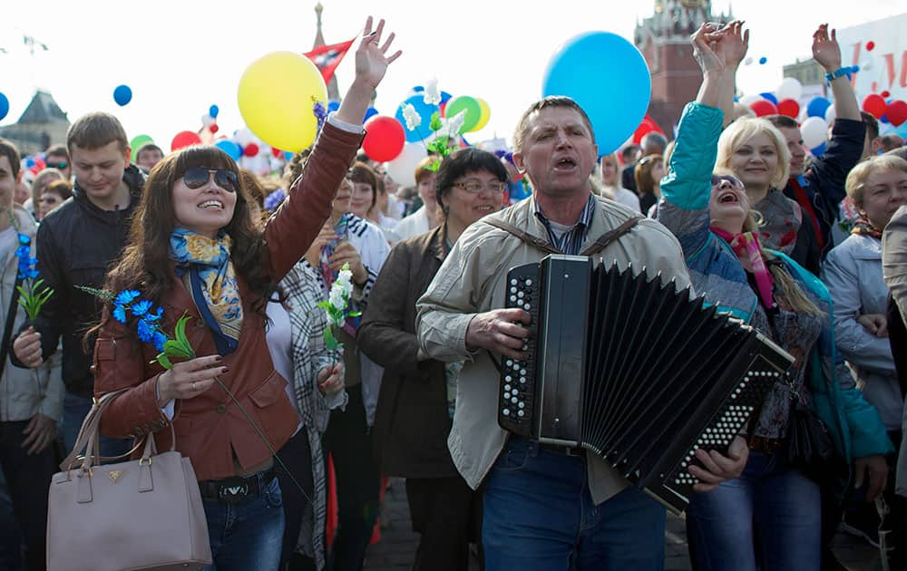 Members of Russian Trade Unions sing as they march during the May Day celebration at the Red Square in Moscow, Russia.