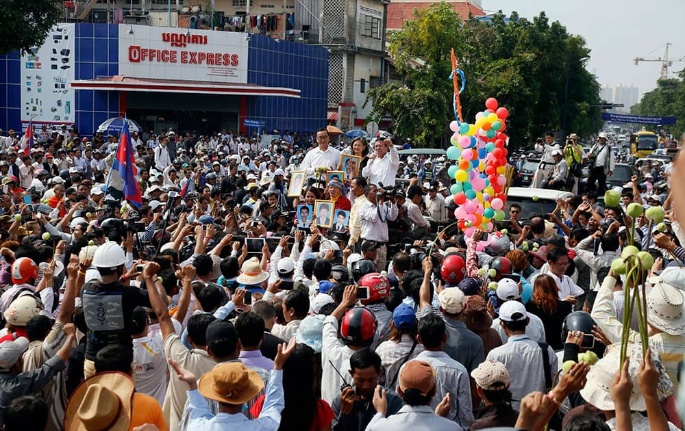 Cambodia`s factory workers and members of the country`s main opposition Cambodia National Rescue Party, cheer as opposition leader Sam Rainsy arrived at a street near Freedom Park in Phnom Penh, Cambodia.