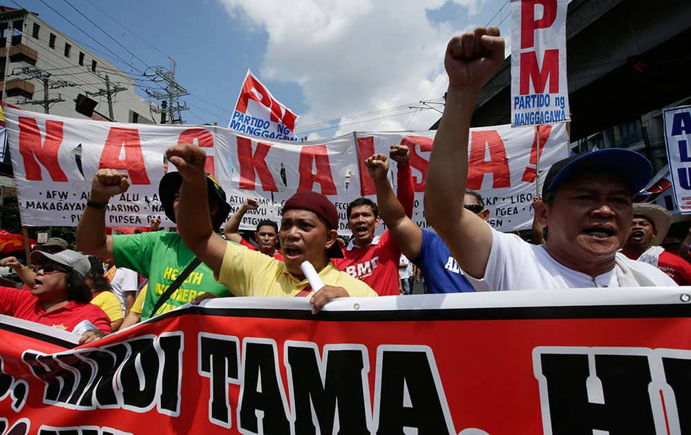 Workers shout slogans as they march towards the Presidential Palace to mark the Labor Day celebrations, in Manila, Philippines.