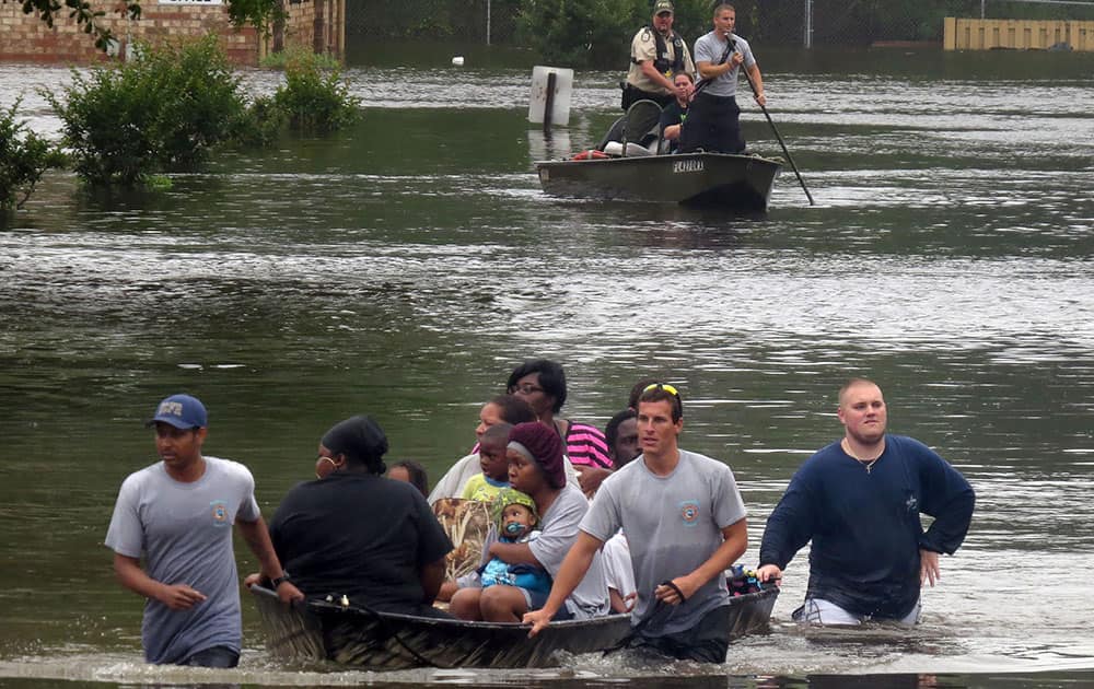 Residents at the Forest Creek Apartments in Pensacola, Fla. Florida are rescued by boat.