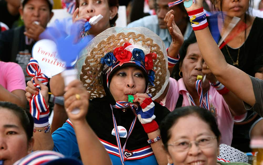 Anti-government protesters blow whistles and cheer during a rally in Bangkok, Thailand.