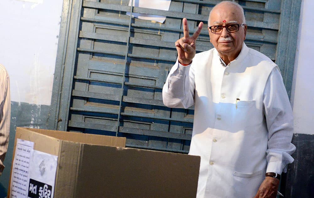 BJP senior leader LK Advani flashes victory sign after casting his vote for Lok Sabha polls at a polling station in Ahmedabad.