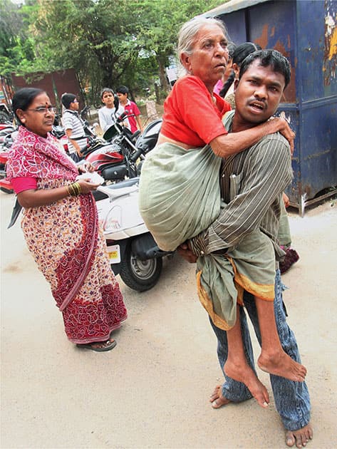 An elderly voter is carried near a polling station in Hyderabad on the voting day.