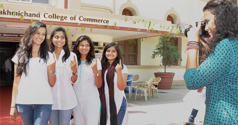 First time voters pose for a photograph after casting votes for Lok Sabha polls at a polling station in Ahmedabad.