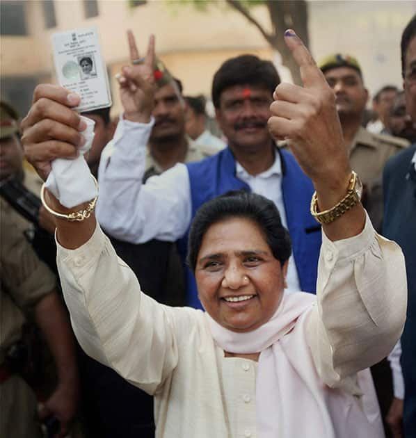 BSP supremo Mayawati shows her voter identity card and inked finger after casting her vote in Lucknow.
