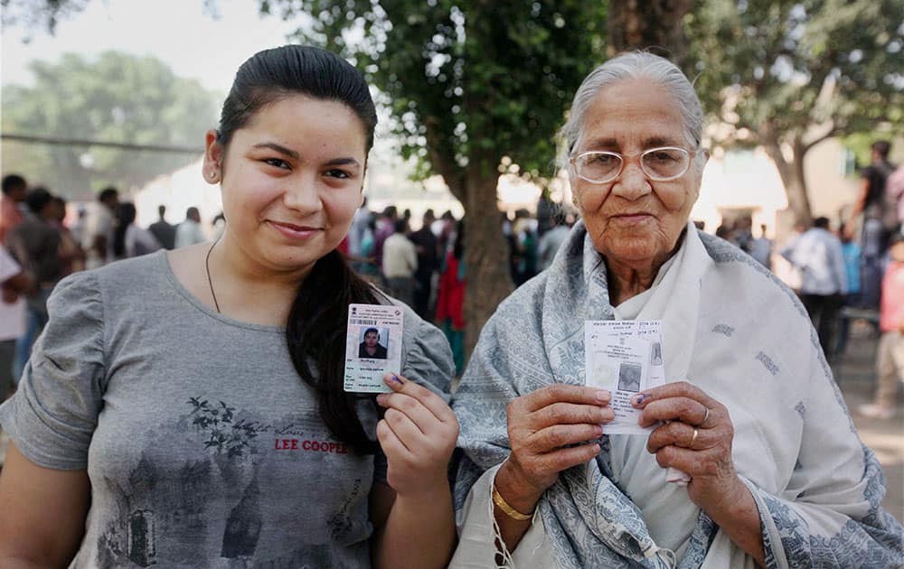 An elderly woman and her grand-daughter after casting votes for Lok Sabha polls at a polling station in Lucknow.