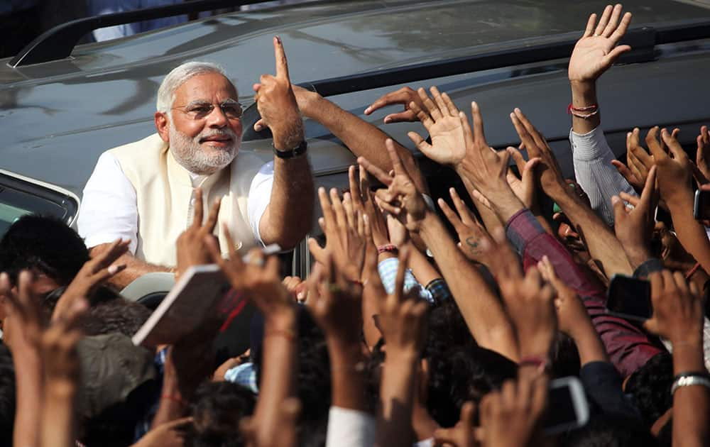 BHARATIYA JANATA PARTY’S PRIME MINISTERIAL CANDIDATE NARENDRA MODI DISPLAYS HIS INKED FINGER TO SUPPORTERS AFTER CASTING HIS VOTE IN AHMEDABAD.