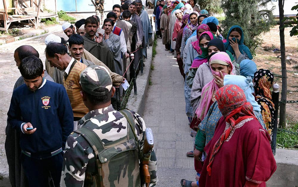 People wait to cast their vote for Srinagar Lok Sabha contituency at a polling station in Ganderbal district.