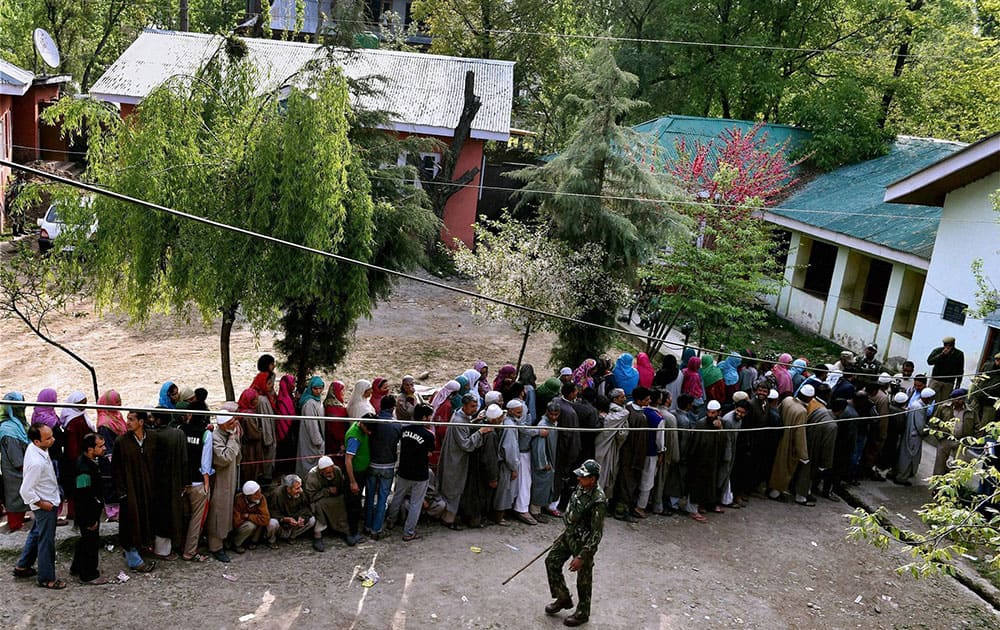 People wait to cast their vote for Srinagar Lok Sabha contituency at a polling station in Ganderbal district.