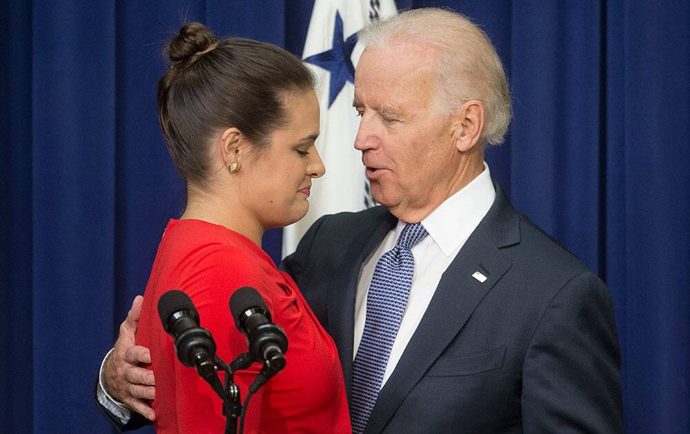 Vice President Joe Biden consoles Madeleine Smith after she recounted her story of being a raped victim while a student at Harvard University, during an event announcing the release of the First Report of the White House Task Force to Protect Students from Sexual Assault, in the South Court Auditorium of the Eisenhower Executive Office Building on the White House complex in Washington.