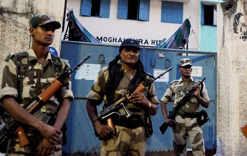 Armed policemen outside a polling booth in old city of Hyderabad.