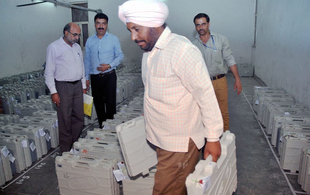 Polling officials at an EVM distribution centre in Hyderabad on Tuesday ahead of elections.