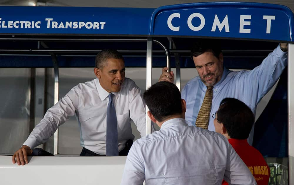 President Barack Obama talks with Ken Montler, CEO Global Electric Transportation Ltd., top right, Freddie Tinga, president, Global Electric Transportation Ltd., lower left, and Robert Martin, Jeepney Driver, lower right, as he views the COMET electric vehicle at the Sofitel Philippine Plaza hotel in Manila, Philippines.