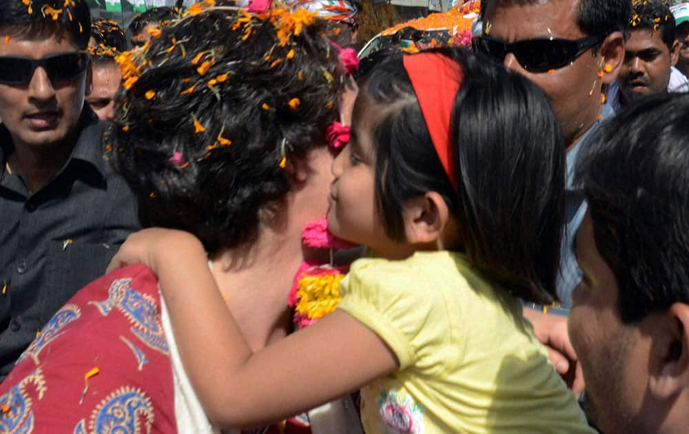 Priyanka Vadra holds a girl during an election campaign for her mother and Congress President Sonia Gandhi in Raebareli.