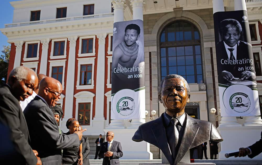 South African President Jacob Zuma points after he and other dignitaries unveiled a bust of former South African President Nelson Mandela at the South African Parliament in Cape Town, South Africa.