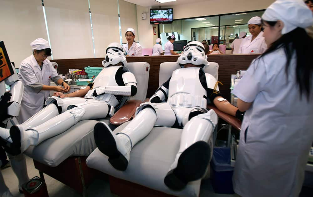 Udomsak Ratanotayo, left, and Suttinan Boonsomkiat wear storm trooper costumes while donating blood at the Thai Red Cross in Bangkok, Thailand. Thai Star Wars fans will donate blood and give toys at an orphanage as part of a promotional campaign. 