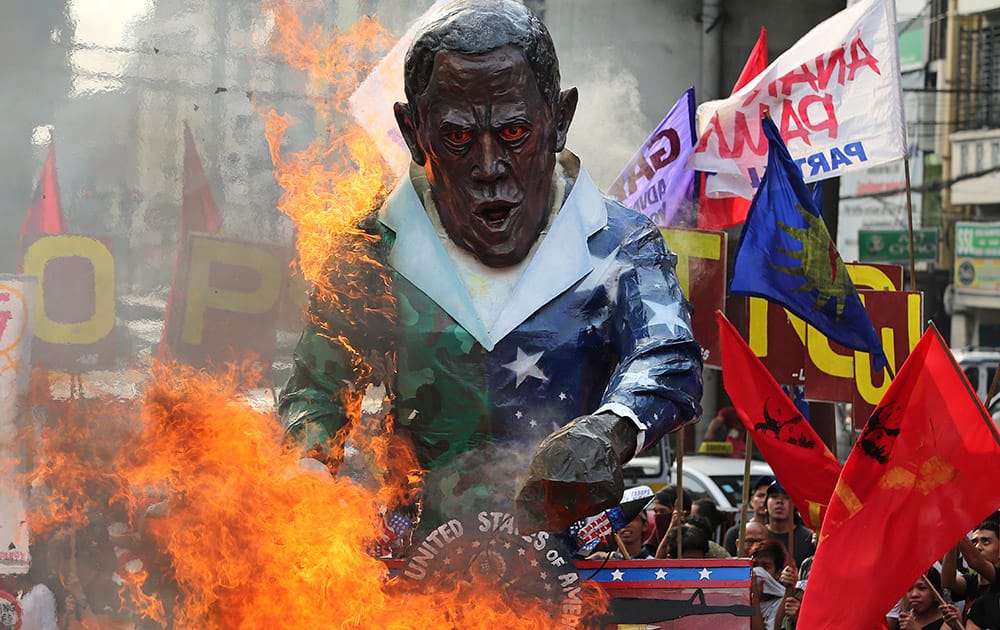 An effigy of US President Barack Obama is burned by Filipino activists during a rally outside the Malacanang presidential palace in Manila, Philippines to oppose the Enhanced Defense Cooperation Agreement between the Philippines and US. 