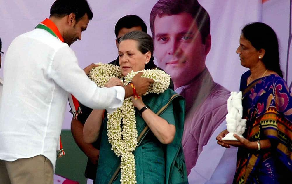 Sonia Gandhi, President AICC, being garlanded by P. Karthik Reddy Congress Lok Sabha Candidate from Chevella Constituency upon her arrival at Chevella Constituency on the outskirts of Hyderabad.