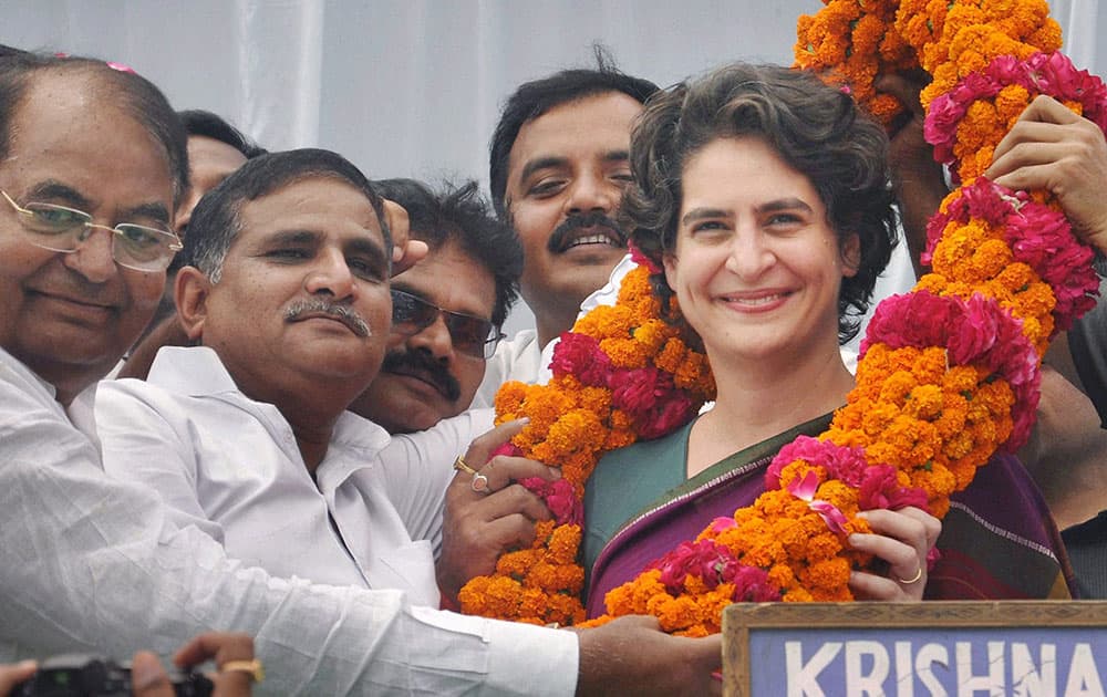 Priyanka Vadra, daughter of Congress party president Sonia Gandhi, receives a floral garland from supporters during an election campaign in her mother’s constituency of Rae Bareli.