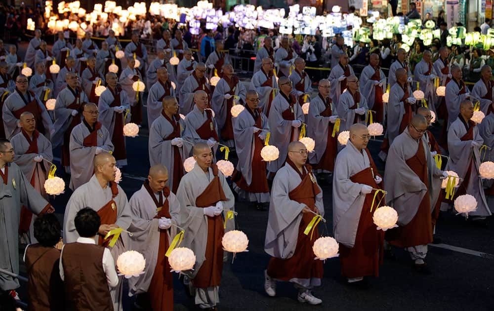 South Korean Buddhist monks carry lanterns in a parade for cherishing the memory of deceased persons and safe return of passengers aboard the sunken ferry boat Sewol during the Lotus Lantern Festival for upcoming birthday of Buddha on May 6, on a street in Seoul, South Korea.