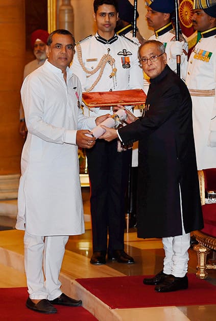 President Pranab Mukherjee presents Padma Shri to actor Paresh Rawal during Padma Awards 2014 function at Rashtrapati Bhavan in New Delhi.