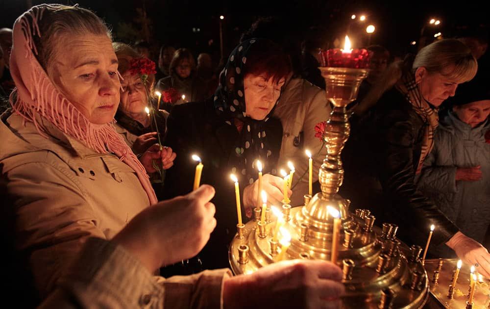 Ukrainians hold lit candles commemorating the 28th anniversary of the Chernobyl nuclear disaster in Kiev, Ukraine.