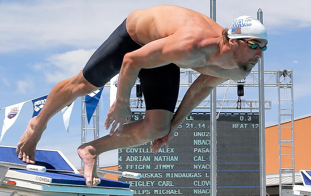 Michael Phelps starts the 50-meter freestyle preliminary heat during the Arena Grand Prix swim event, in Mesa, Ariz.