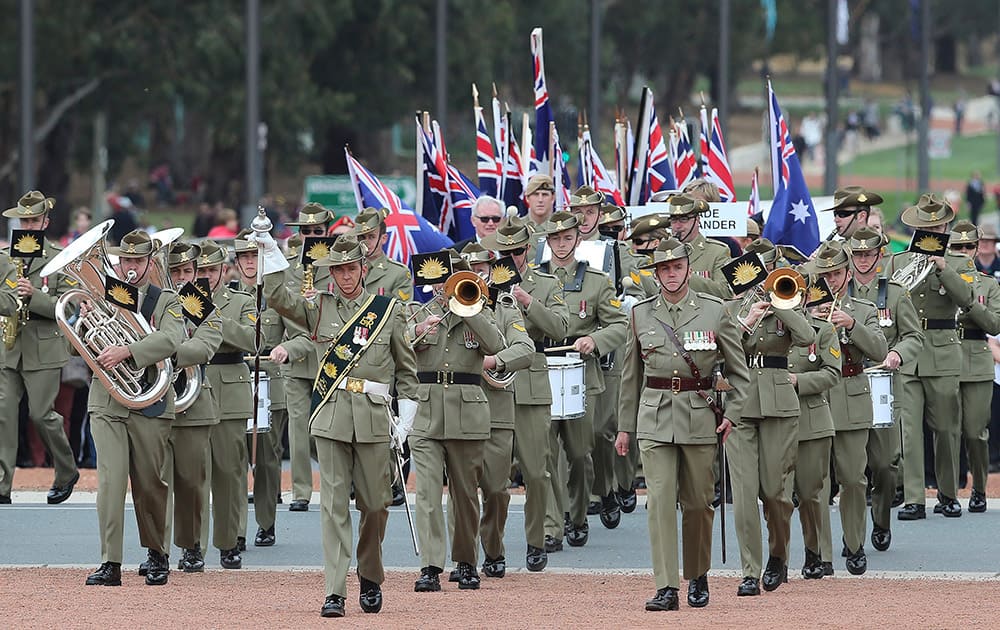 A military band marches onto the parade ground on Anzac Day at the Australian War in Canberra, Australia.