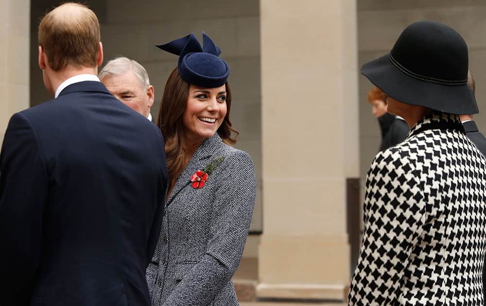 Britain`s Prince William, left, and his wife Kate, the Duchess of Cambridge, center, visit the Australian National War Memorial on Anzac Day in Canberra, Australia.