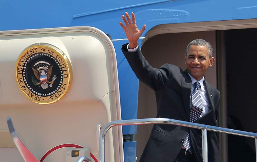 President Barack Obama waves as he boards Air Force One at Haneda Airport in Tokyo, en route to Osan Air Base in Osan, South Korea.