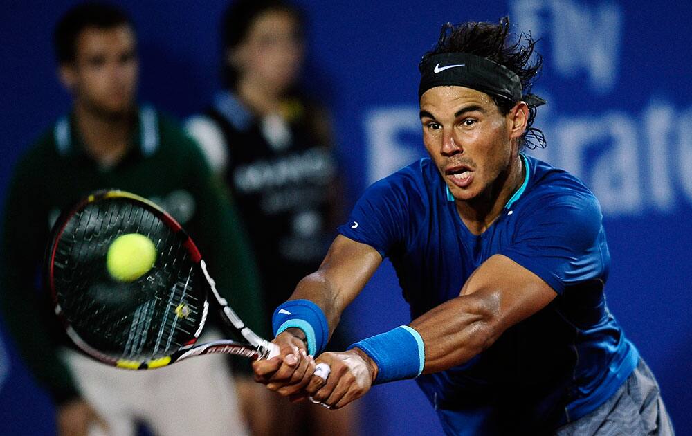 Rafael Nadal of Spain returns the ball to Ivan Dodig from Croatia, during the Barcelona open tennis in Barcelona, Spain.