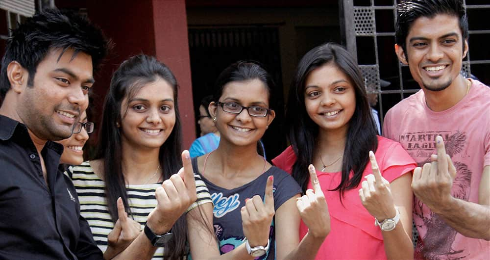 First time voters show their inked fingers after casting votes for Lok Sabha polls at a polling booth in Mumbai.