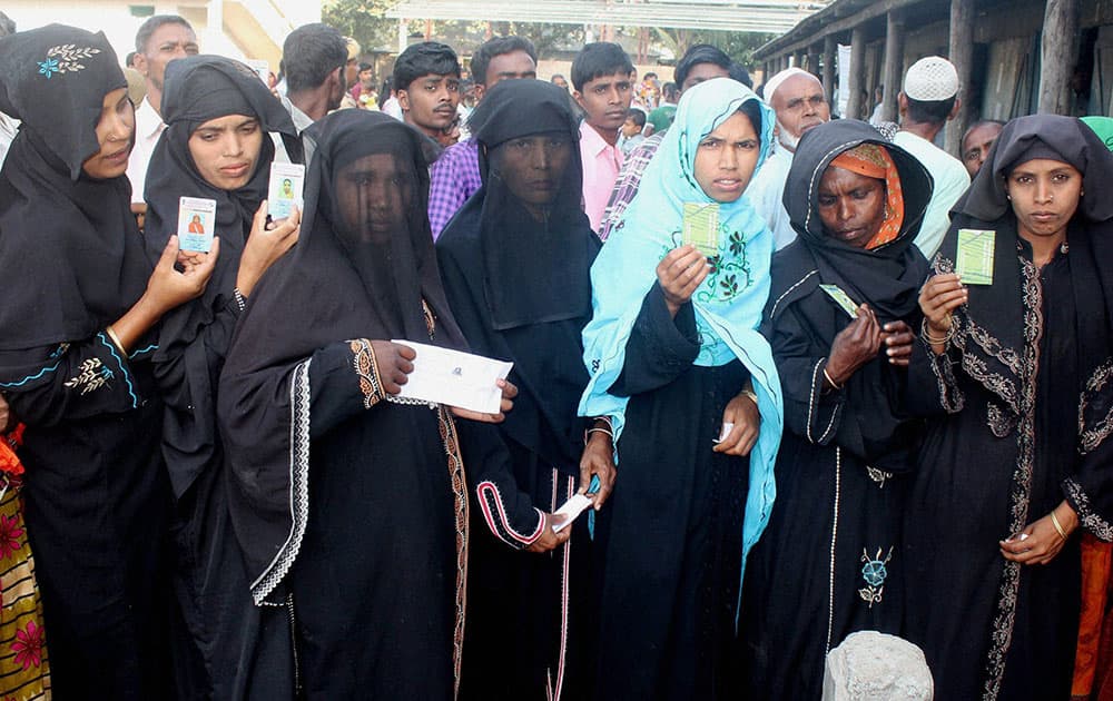 Muslim woman voters standing in a queue to cast their votes at a polling station in Dhuburi.