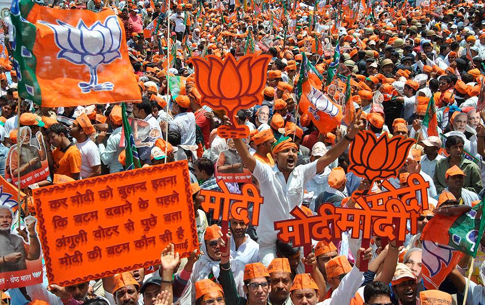 BJP supporters during a road show by BJP Prime ministerial candidate Narendra Modi before filing his nomination papers in Varanasi.