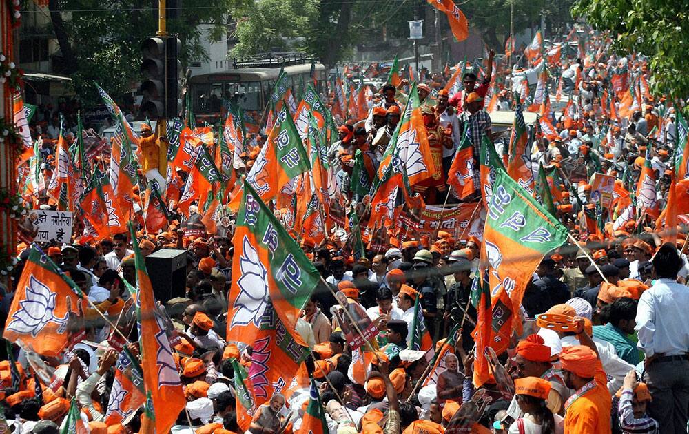 BJP supporters during a road show by BJP Prime ministerial candidate Narendra Modi before filing his nomination papers in Varanasi.