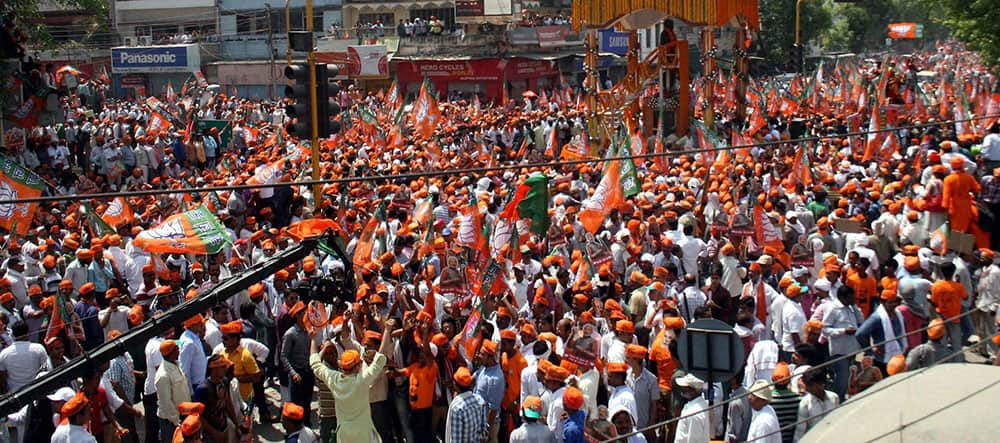 BJP supporters during a road show by BJP Prime ministerial candidate Narendra Modi before filing his nomination papers in Varanasi.