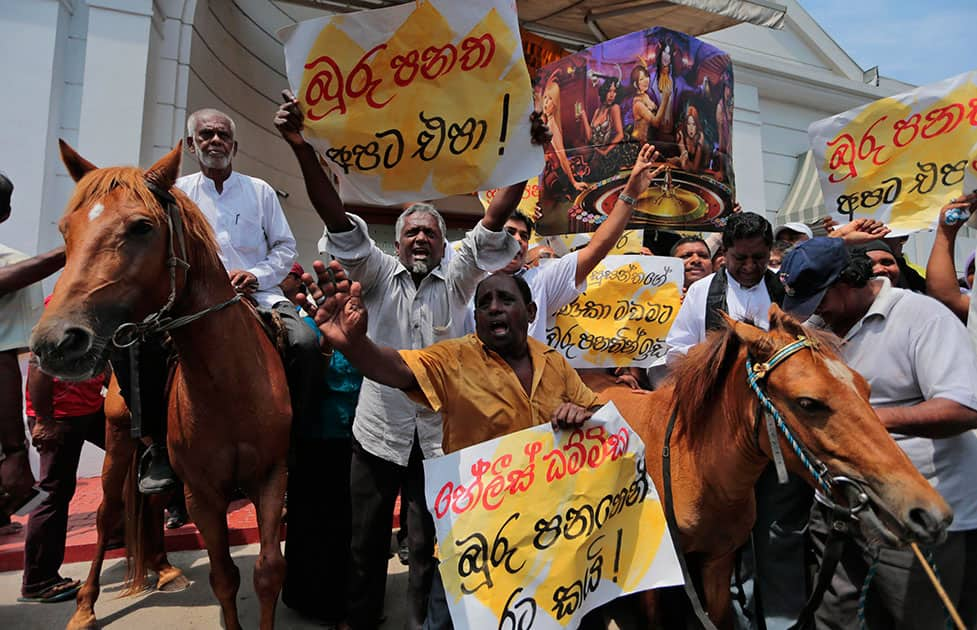 A supporter of the Sri Lanka`s main opposition United National Party rides a pony as others shout slogans during a protest at the venue of a proposed casino project in Colombo, Sri Lanka.