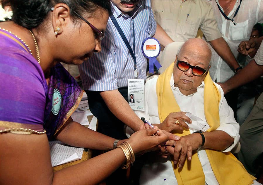 DMK chief M Karunanidhi gets ink mark on his finger before casting his vote, in Chennai.