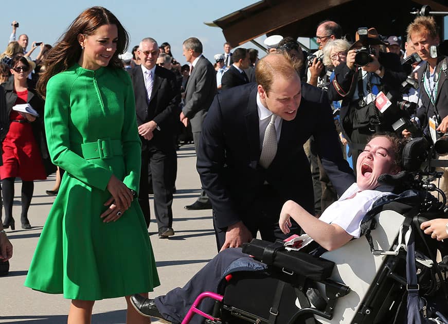 Britain`s Prince William, center, and his wife Kate, the Duchess of Cambridge meet young handicapped children during a visit to plant a tree at the National Arboretum in Canberra, Australia.
