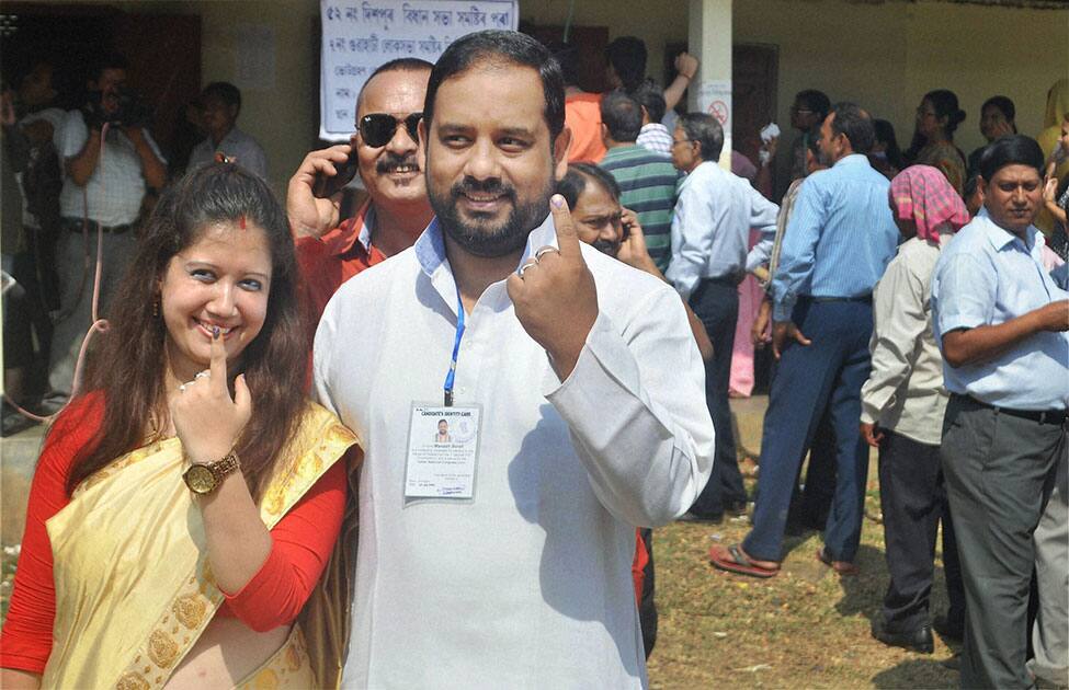 Congress candidate for the Guwahati Lok Sabha constituency Manas Bora and his wife shows their inked finger after casting his vote for Lok Sabha elections in Guwahati.